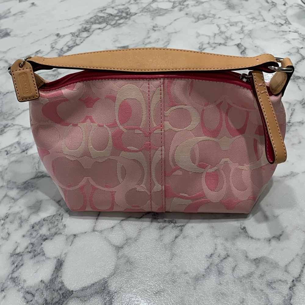 Pink and Tan Coach small purse with zipper and credit card pocket inside.